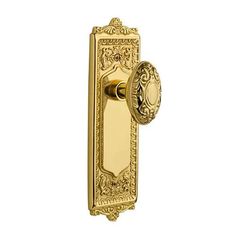 an ornate brass door handle on a white background