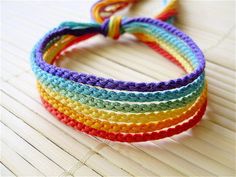 multicolored crocheted bracelets on top of each other with a knot at the end