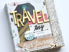 an altered book with the word travel on it's cover and some other items