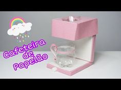 a pink box with a cup inside and a rainbow in the sky above it that says cafeteria de papelo