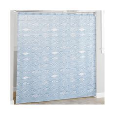 a blue shower curtain with white fish and waves in the water on it's side