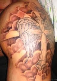 the back of a man's arm with an angel and cross tattoo on it