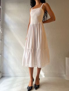 - Vintage Jessica white midi dress - Cotton poly blend - Made in Canada - Tagged 36 Bust: 15.5" Waist: 13.5" Length: 48" We are not responsible for lost, stolen, or damaged packages once they have been shipped. Any additional customs duties or taxes incurred on international orders are the responsibility of the buyer. Please note that our items are vintage and may have minor flaws or imperfections due to their age, which adds to their unique character. White Knee-length Midi Dress For Spring, White Fitted Knee-length Sundress, White A-line Midi Dress For Garden Party, Fitted Midi Sundress For Daywear, Fitted Midi Length Sundress For Daywear, White Midi Dress For Spring, Cotton Midi Dress For Garden Party, Feminine Midi Sundress For Day Out, Feminine Midi Length Sundress For Day Out