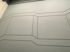 a white wall with black lines on it