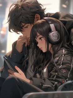 two people sitting next to each other with headphones on and one holding a tablet