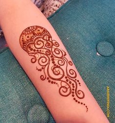 a woman's arm with a henna tattoo on it