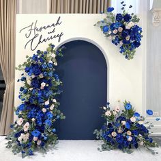 two blue and white flowers are on display in front of a sign that says, hannah & henry