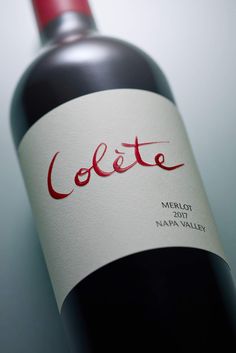 a bottle of red wine with the word colette written in red on it's label