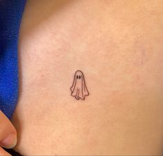 a small ghost tattoo on the stomach