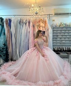 Step into your fairytale moment with this enchanting pink off-the-shoulder Quinceanera ball gown. This dress is crafted from luxurious tulle fabric, offering volume and elegance in every movement. The soft pink hue adds a touch of youthful charm, perfect for celebrating your special day. The off-the-shoulder neckline gracefully frames the shoulders, while intricate appliqued embellishments enhance its romantic appeal. A sweeping train adds a regal finish, making every step memorable. The lace-up Vestidos Color Fucsia, Pink Sweet 16 Dress, Princess Quinceanera Dresses, Xv Ideas, Women Celebrating, Pink Sweet 16, Dresses Off Shoulder, Vestidos Color Rosa, Flora Dress