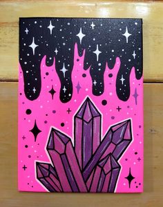 a pink and black painting on wood with stars in the sky behind it is an image of a crystal cluster