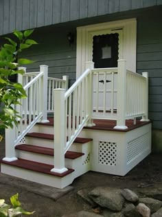 a house with white railings and red steps