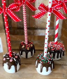 three chocolate covered candy canes with bows on them