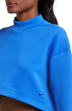 An oversized mock-neck sweatshirt features moisture-wicking Dri-FIT techology that keeps you comfy, while a cropped length creates a cool, modern look. 15 1/2" front length; 18" back length (size Medium) Mock neck 93% polyester, 7% spandex Machine wash, tumble dry Imported Sports Top With Relaxed Fit And Funnel Neck, Functional Funnel Neck Tops For Fall, Functional Fall Tops With Funnel Neck, Nike Athleisure Sweatshirt For Spring, Spring Sporty Funnel Neck Sweatshirt, Sporty Funnel Neck Top With Ribbed Cuffs, Sporty Top With Funnel Neck And Ribbed Cuffs, Athleisure Funnel Neck Top With Ribbed Collar, Sporty Tops With Funnel Neck And Ribbed Cuffs