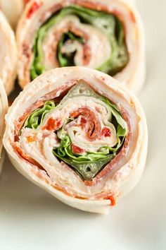 several wraps with meat and vegetables on them