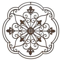 an ornate metal wall hanging decoration with leaves and scrolls on the center, in brown