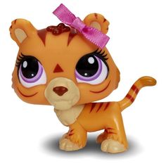 a little tiger toy with big eyes and a pink bow on it's head