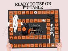 someone holding up a board game called creepy to use or editable for their halloween party