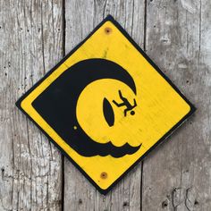 a yellow and black sign with an image of a man's face on it