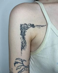 a woman with a tattoo on her arm holding a knife in one hand and an arrow in the other