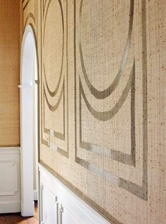 the wall is decorated with an art deco pattern and white trim on it's edges