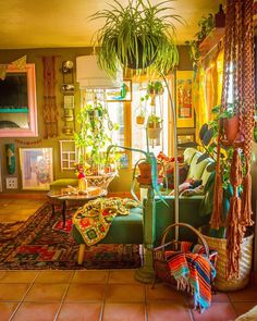 a living room filled with lots of furniture and plants