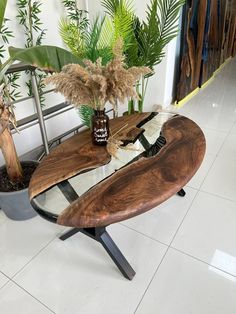 a wooden table sitting on top of a white tiled floor next to potted plants