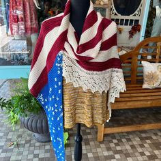 a red, white and blue shawl on display in front of a store