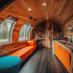 an orange couch sitting in the middle of a living room next to a counter top