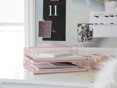 a desk with some books on it and a feather in front of the glass window