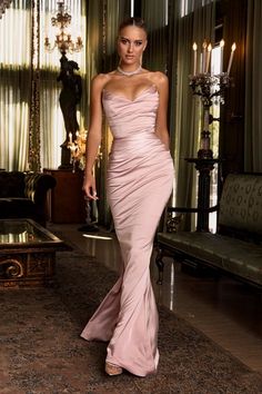 It's all about feminine tones and languid, sexy drapes. Our 'Nina' gown is cut from our luxuriously soft duchess satin in a delicate blush hue and has a beautiful feminine drape. 'Nina' will look so chic and elegant as a modern gown and is also perfect for Formals, Balls and Events. The strapless, peaked neckline is so elegant and has a boned bodice for structure and support to ensure it flatters every shape.The skirt hugs every curve as it falls to the knee then flares out to an ultra feminine Blush Pink Dress Formal Elegant, Blush Evening Gown, Dress Formal Elegant, Mermaid Corset, Celebrity Event, Pink Evening Gowns, Gala Gowns, Modern Gown, Corset Gown