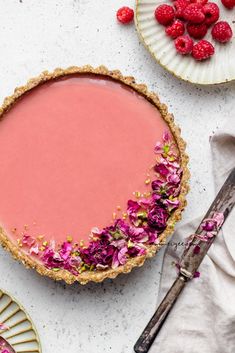 a raspberry pie with pink flowers on top