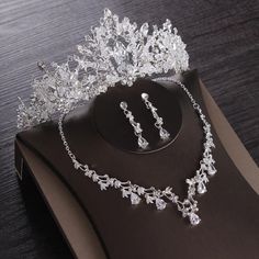 a tiara and earrings on display on a table