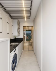 a laundry room with a washer and dryer next to the kitchen counter top