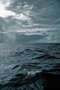 the ocean is full of waves and dark clouds