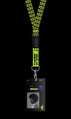 a lanyard with an id card attached to the lanyard, which has a black and green design on it