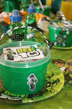 a green plastic container sitting on top of a table covered in plates and napkins