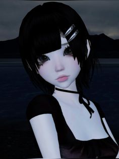 a woman with black hair and bangs standing in front of the ocean at night time