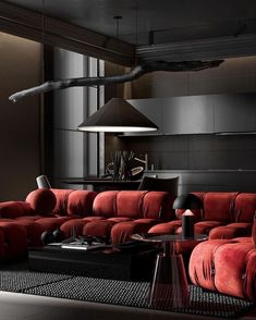 a living room filled with red couches and black tables