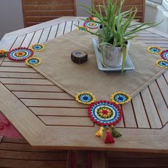 a wooden table topped with a potted plant