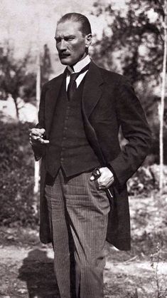 an old black and white photo of a man in a suit