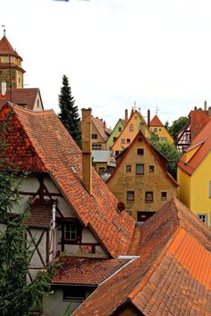 the rooftops of houses are covered in red tile and brown shingled roof tiles