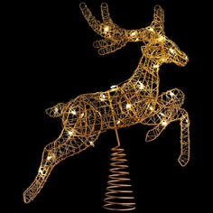 a lighted reindeer on top of a christmas tree in the shape of a spiral wire