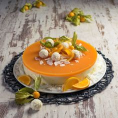 a cake with oranges and other fruits on it