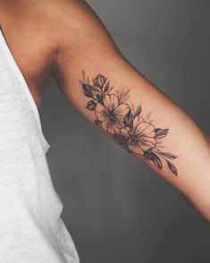 a woman with a flower tattoo on her arm