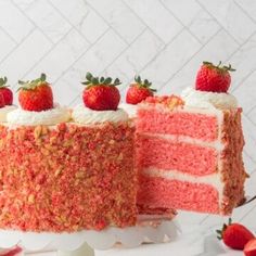 there is a strawberry cake with white frosting and strawberries on the top slice