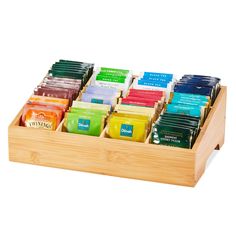 a wooden tray filled with different types of teas