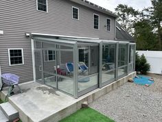 an enclosed patio with two lawn chairs on it