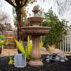 a bird bath sitting in the middle of a garden