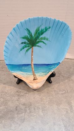 a palm tree painted on a blue plate